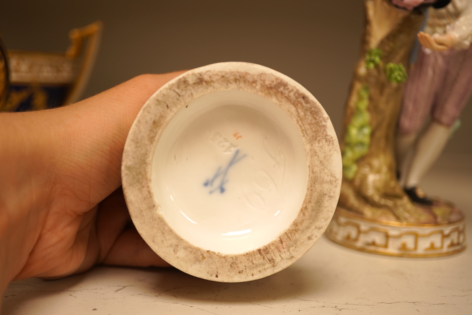 A pair of 19th century Meissen figurines, a Crown Derby figure, a pair of miniature figures and a Leeds type creamware group of Venus and Cupid, tallest 18cm high.
